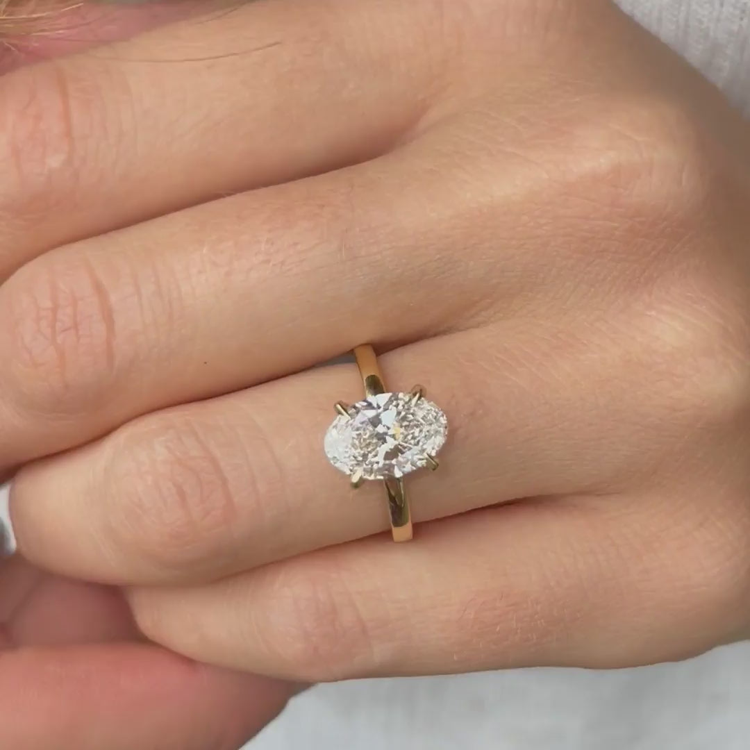 Model showing the Sira 4ct oval diamond ring with hidden halo accents