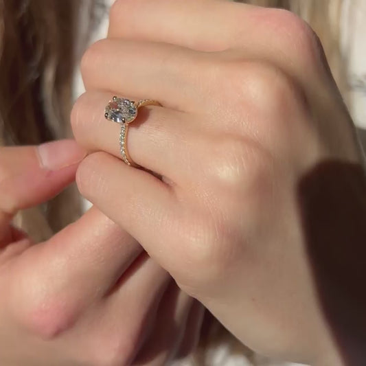 Model showing off yellow gold 1.5 carat diamond engagement ring set with sustainable environmentally friendly lab created diamonds in cornwall