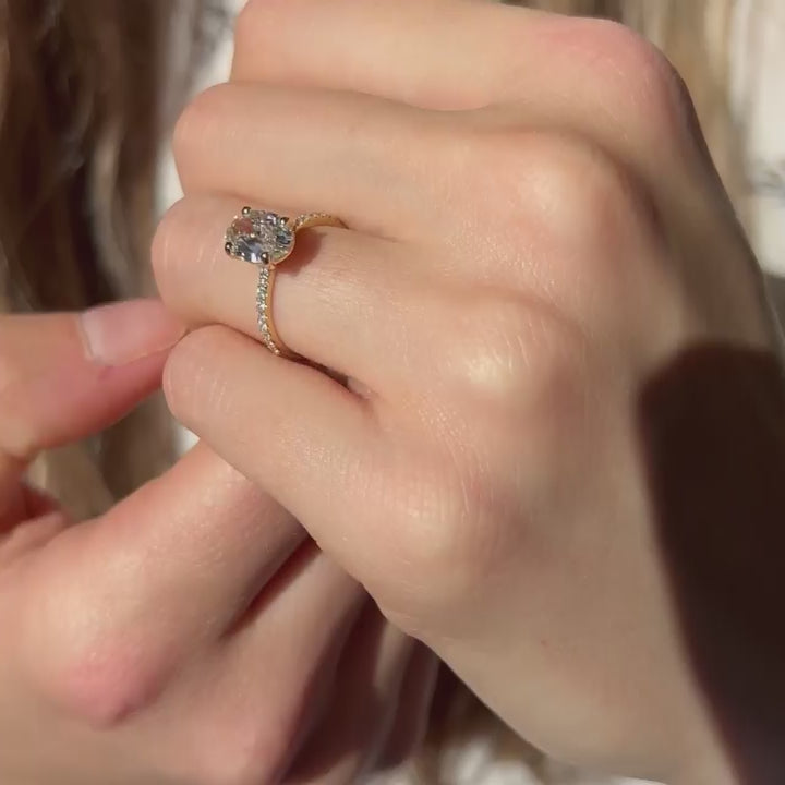 Model showing off yellow gold 1.5 carat diamond engagement ring set with sustainable environmentally friendly lab created diamonds in cornwall